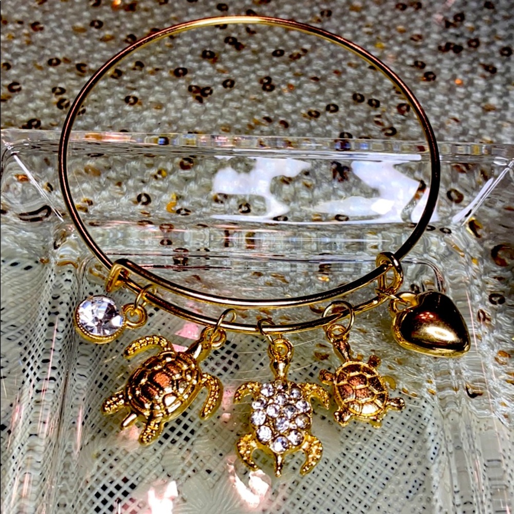 Gold Tone Bracelet With Five Charms.